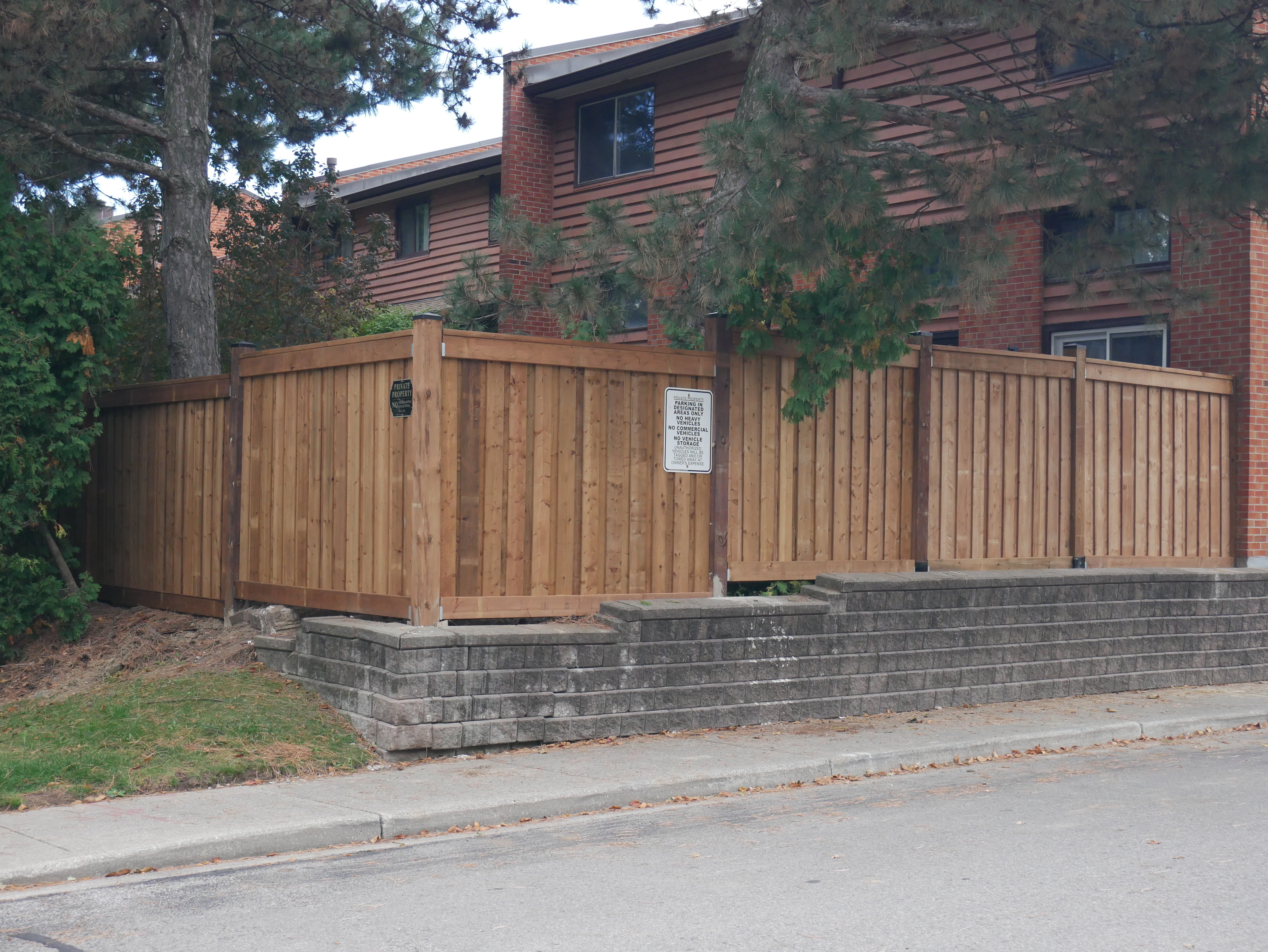 Completed cedar fence and gate installation on a residential property